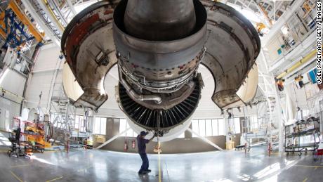 A aircraft maintenance technician works on the engine of an Airbus airplane of the airline company Air France in a maintenance facility at Roissy-Charles de Gaulle Airport, in Roissy, north of Paris, on June 27, 2019. (Photo by JOEL SAGET / AFP)        (Photo credit should read JOEL SAGET/AFP/Getty Images)